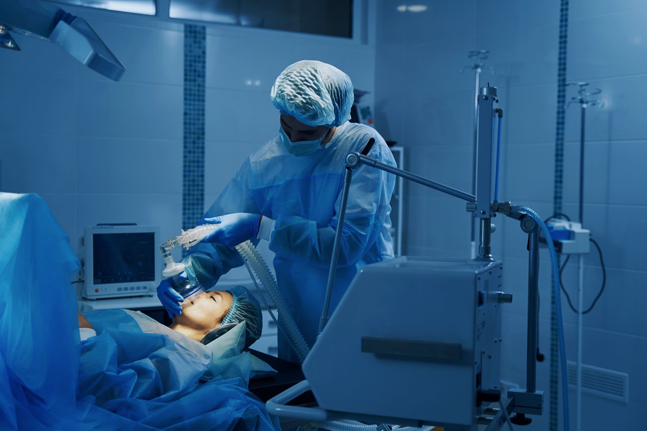 Anesthesiologist administering anesthesia in the operating room